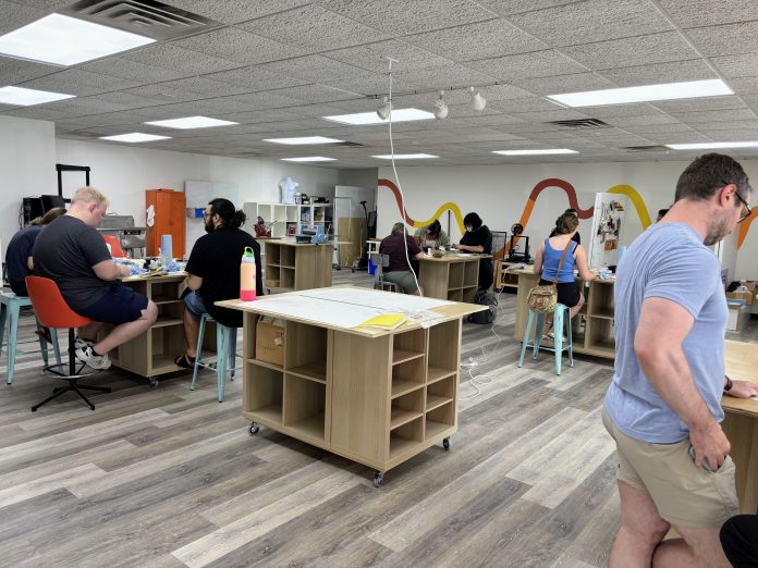 People sit in an open studio space