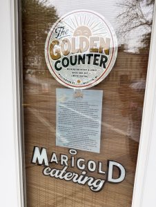 A door to a business with a paper sign announcing a temporary closure