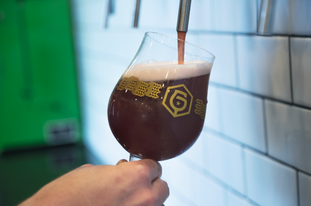 A beer glass being filled at a tapline