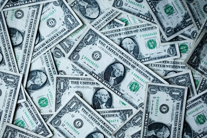 Multiple dollar bills scattered