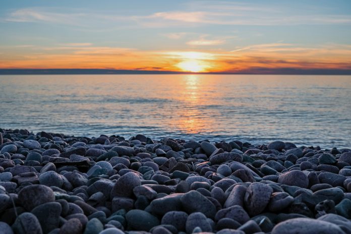 Rocks and a lake with a sunset