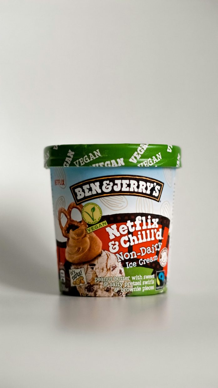 A pint of Ben & Jerry's ice cream sealed and in front of a white wall