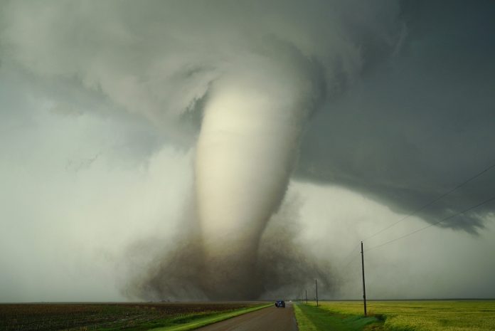 A large tornado by a road