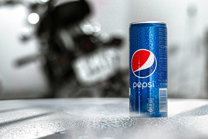 A Pepsi can with a blurred gray background