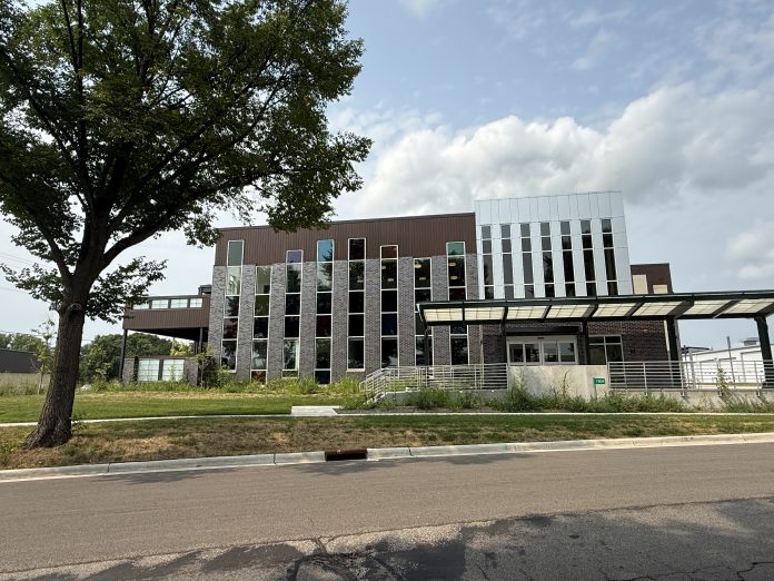 The outside of a building with clouds and trees
