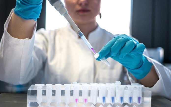 A lab worker with vials
