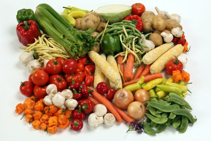 A variety of vegetables on a white table