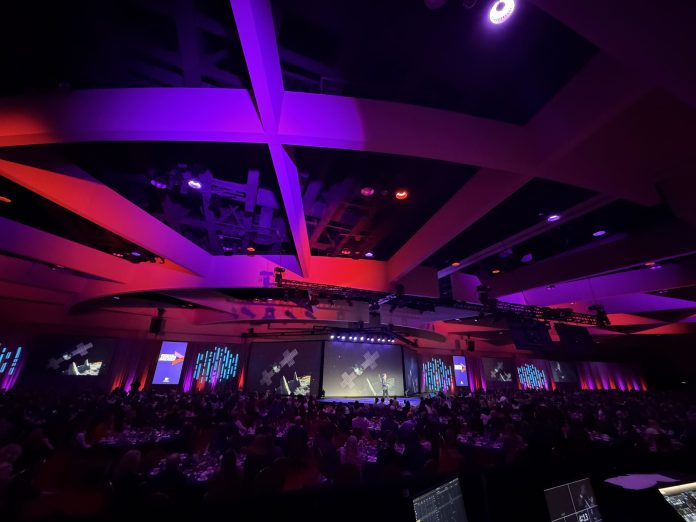 A room full of people at tables