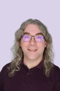 A man in glasses posing for a headshot