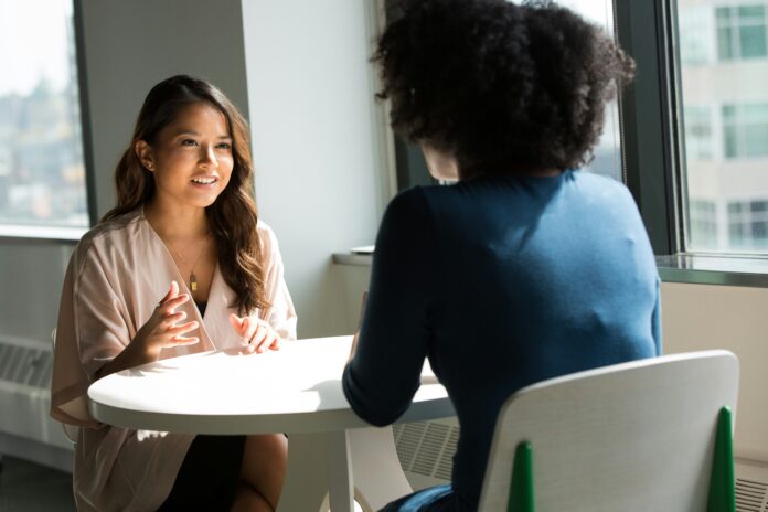 Two people sitting at a table for a job interview